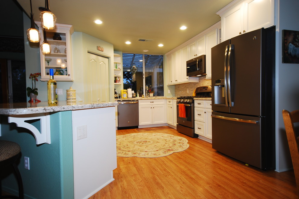Transitional kitchen photo with flat-panel cabinets and white cabinets