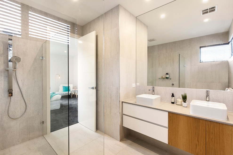 Contemporary bathroom in Melbourne with flat-panel cabinets, medium wood cabinets, an open shower, beige tile, beige walls, a vessel sink and an open shower.