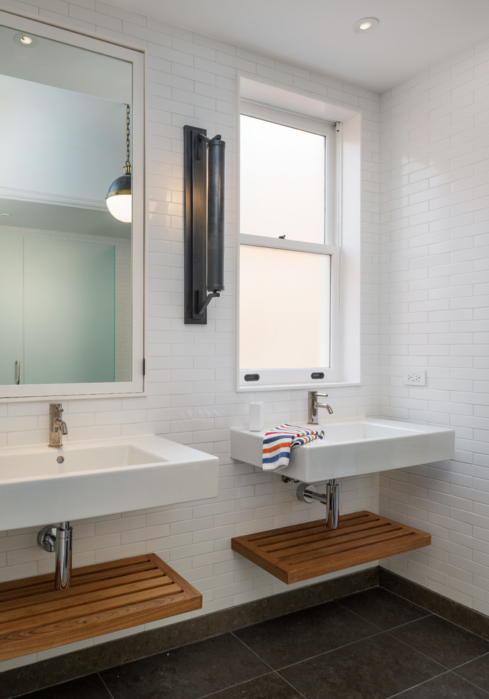 Transitional bathroom in San Francisco with a wall-mount sink and white tile.
