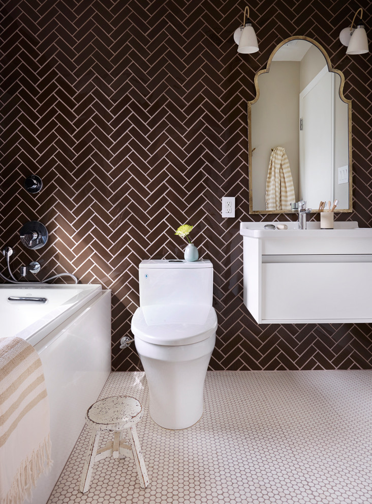 Inspiration for a mid-sized eclectic master bathroom in San Francisco with flat-panel cabinets, white cabinets, a drop-in tub, a corner shower, a one-piece toilet, brown tile, glass tile, brown walls, mosaic tile floors, a wall-mount sink and solid surface benchtops.