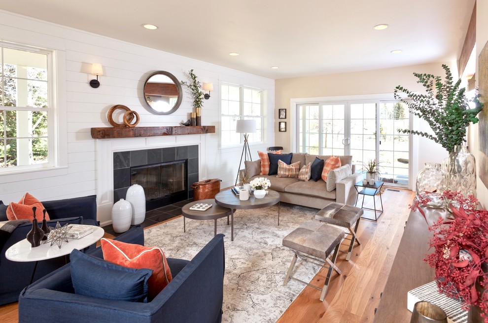 Inspiration for a mid-sized country formal enclosed living room in Other with white walls, medium hardwood floors, a standard fireplace, a stone fireplace surround, no tv and brown floor.