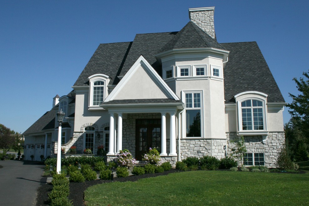 Example of a mid-sized transitional gray two-story mixed siding house exterior design with a hip roof and a shingle roof