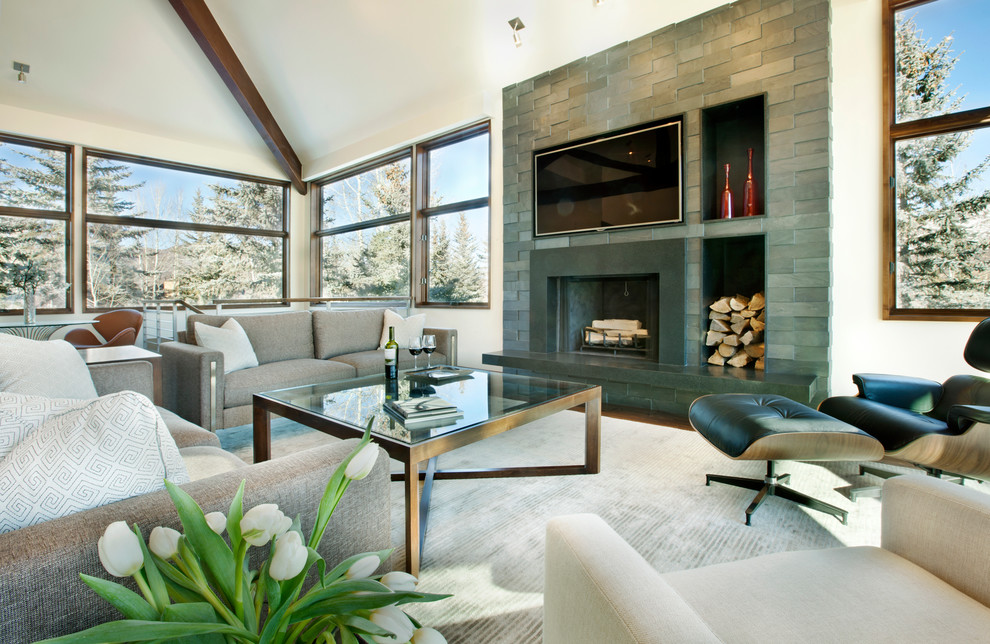 Design ideas for a large contemporary open concept living room in Denver with medium hardwood floors, a standard fireplace, a stone fireplace surround, a wall-mounted tv and white walls.