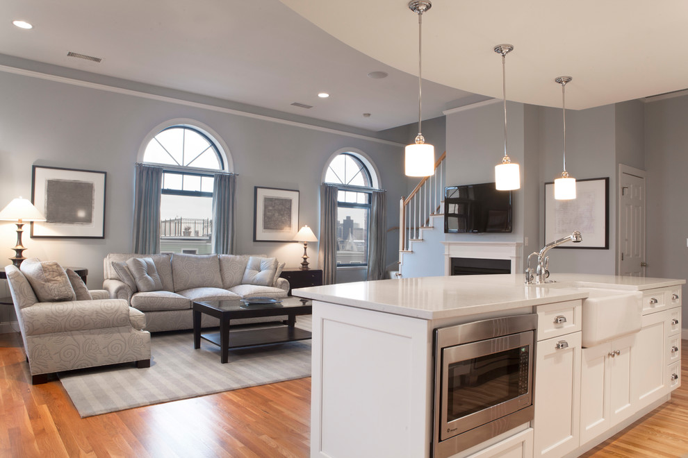 Eat-in kitchen - large transitional porcelain tile eat-in kitchen idea in Boston with an undermount sink, raised-panel cabinets, white cabinets, granite countertops, beige backsplash, travertine backsplash, stainless steel appliances and green countertops