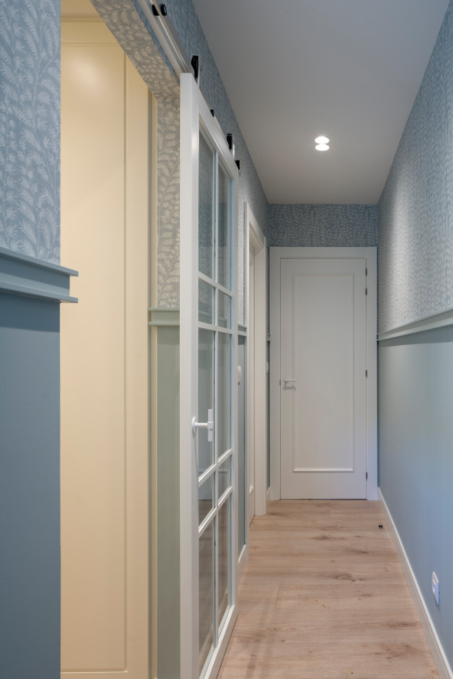 Ispirazione per un ingresso o corridoio classico di medie dimensioni con pareti blu, pavimento in laminato, pavimento beige e carta da parati