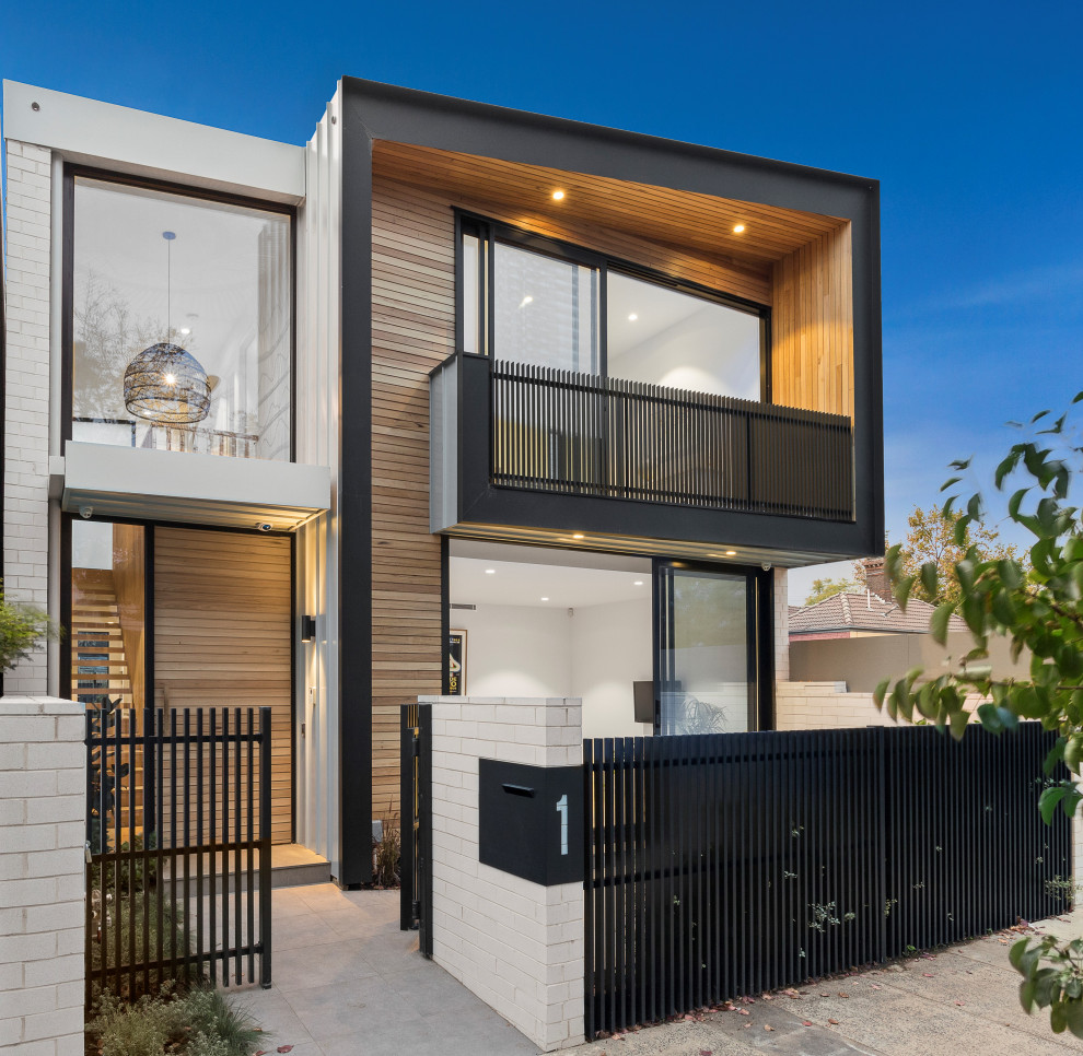 This is an example of a contemporary multi-coloured house exterior in Melbourne with a flat roof.