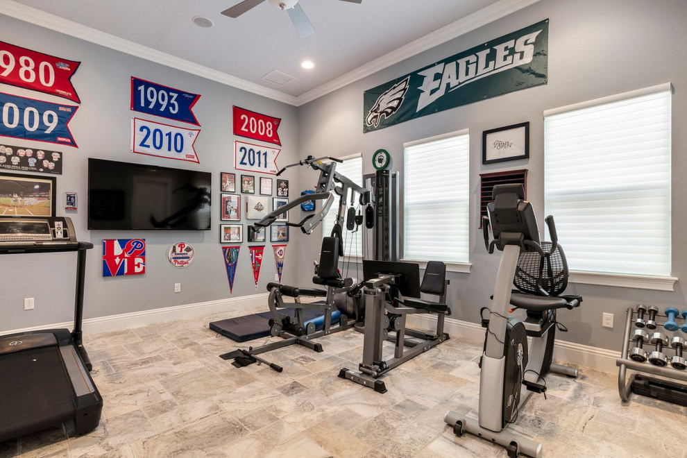 This is an example of a large transitional multipurpose gym in Orlando with grey walls, travertine floors and grey floor.