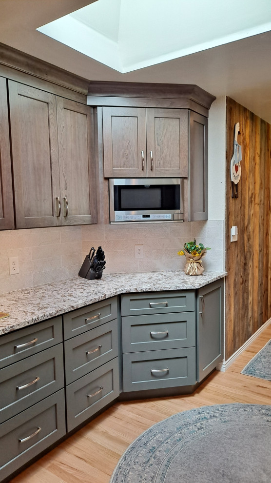 Inspiration for a mid-sized transitional galley light wood floor kitchen remodel in Denver with shaker cabinets, porcelain backsplash and stainless steel appliances