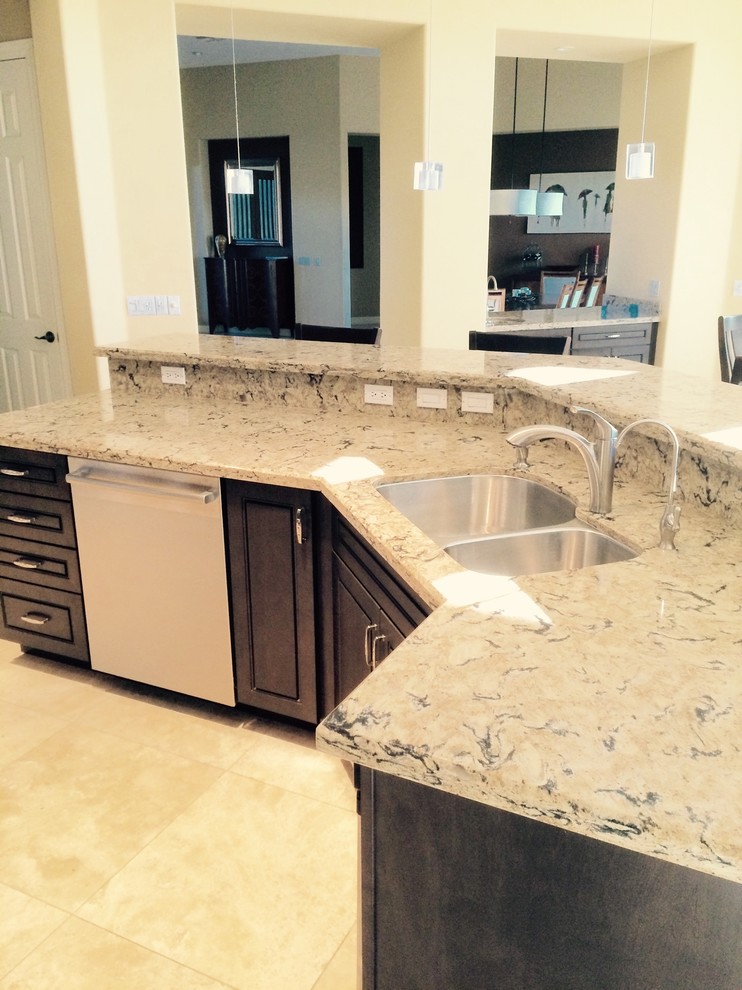 Example of a large transitional l-shaped ceramic tile and beige floor kitchen design in Phoenix with a double-bowl sink, raised-panel cabinets, dark wood cabinets, granite countertops, multicolored backsplash, stone slab backsplash, stainless steel appliances and an island