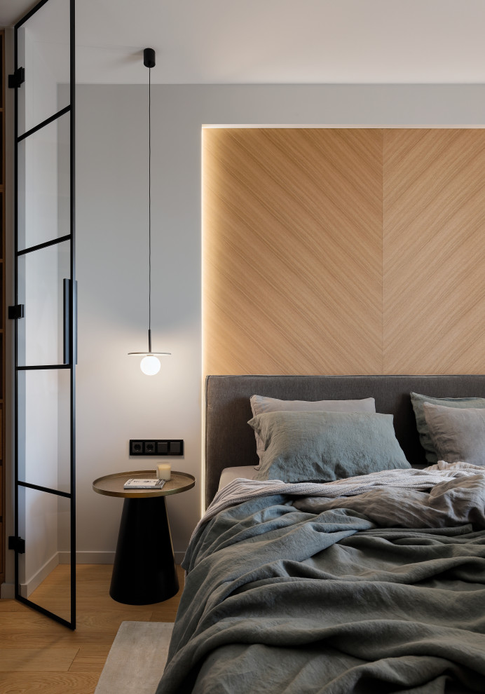На фото: спальня среднего размера в современном стиле с серыми стенами, паркетным полом среднего тона и коричневым полом с
