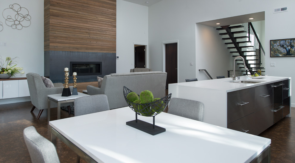 This is an example of a large modern open concept living room in Seattle with white walls, concrete floors, a ribbon fireplace, a wood fireplace surround and no tv.