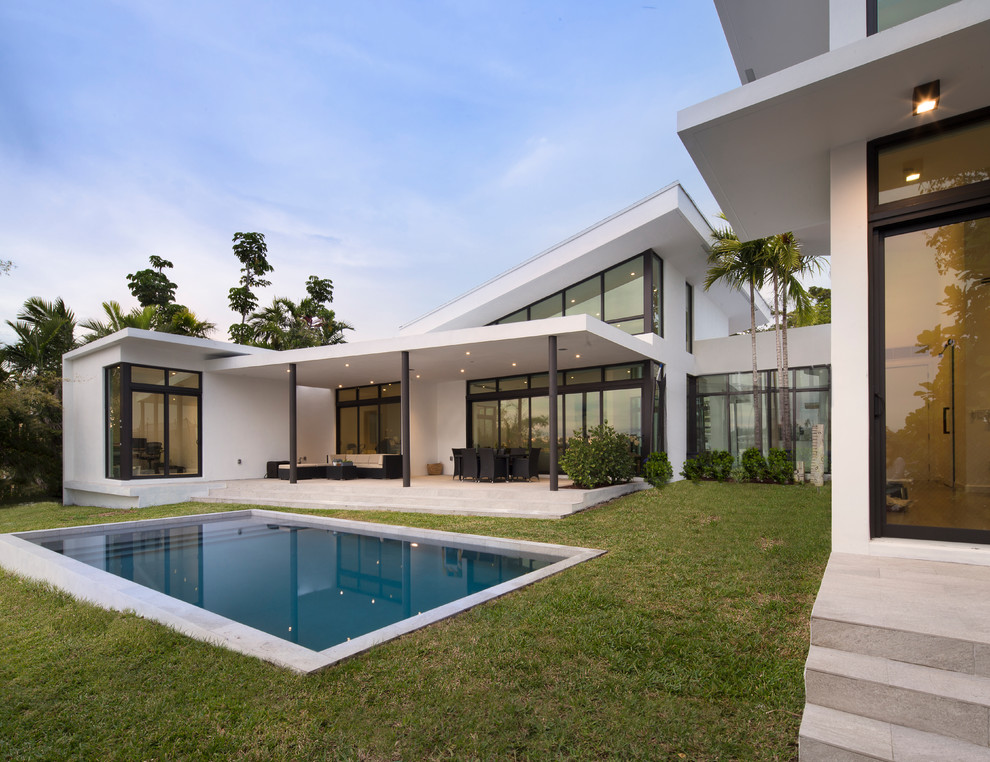 Design ideas for a contemporary backyard rectangular lap pool in Miami.