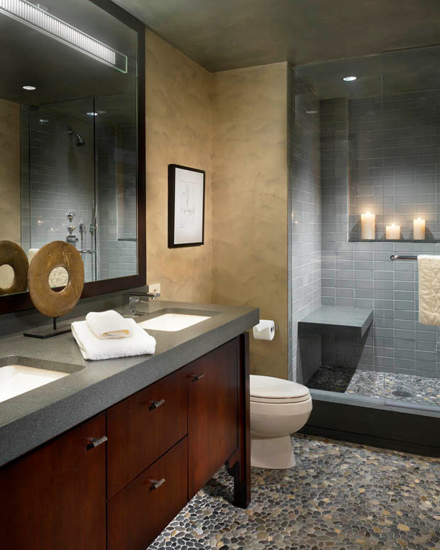Master bathroom in Chicago with a vessel sink, flat-panel cabinets, dark wood cabinets, soapstone benchtops, an open shower, gray tile, subway tile, beige walls and pebble tile floors.
