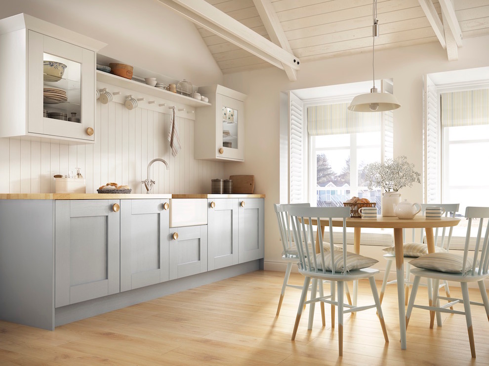 Design ideas for a country single-wall eat-in kitchen in Sussex with a farmhouse sink, shaker cabinets, blue cabinets, wood benchtops, white splashback, timber splashback, light hardwood floors and no island.