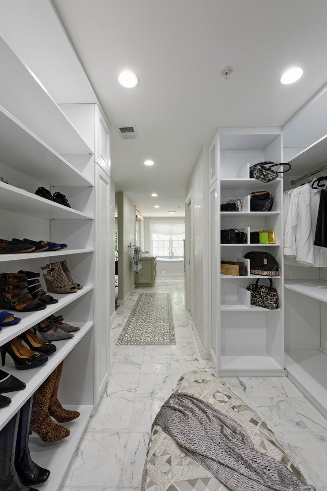 Large transitional gender-neutral walk-in wardrobe in DC Metro with raised-panel cabinets, white cabinets, marble floors and white floor.