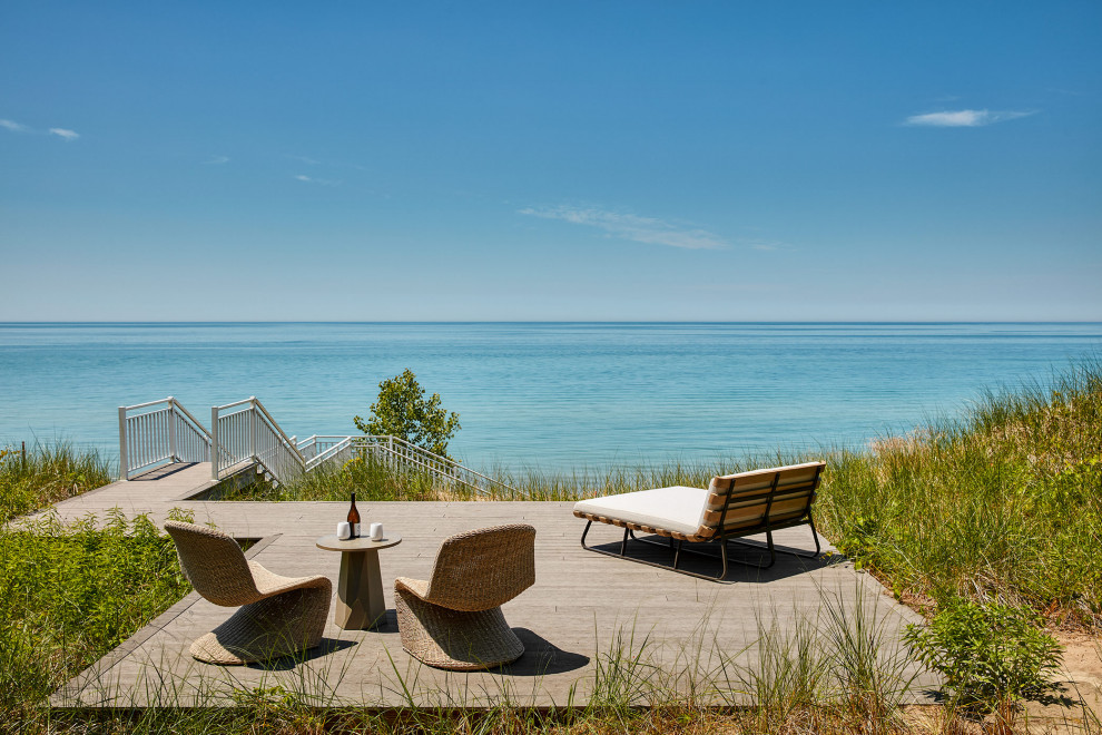 Design ideas for a beach style ground level deck in Chicago with with dock and no cover.