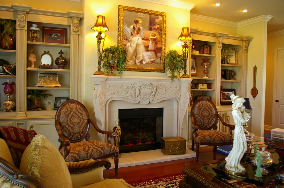 Photo of a mediterranean formal enclosed living room in Oklahoma City with beige walls, a standard fireplace, a stone fireplace surround and no tv.