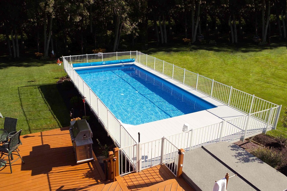 Photo of a mid-sized backyard rectangular aboveground pool in Boston with decking.