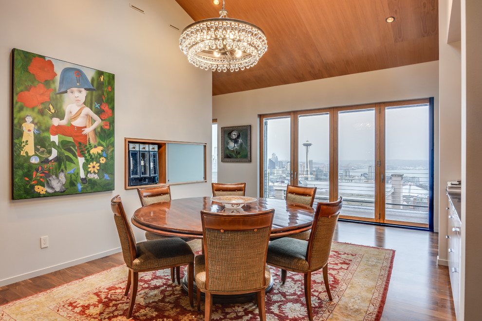 Mid-sized minimalist dark wood floor enclosed dining room photo in Seattle with white walls and no fireplace