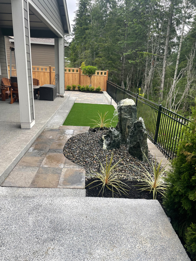 Design ideas for a medium sized eclectic back xeriscape garden in Seattle with concrete paving.