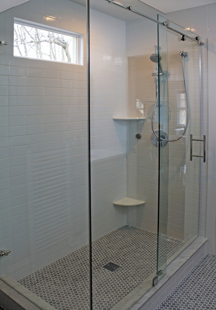 Design ideas for a mid-sized contemporary master bathroom in Philadelphia with flat-panel cabinets, grey cabinets, a corner shower, a one-piece toilet, white tile, subway tile, blue walls, marble floors, a trough sink, engineered quartz benchtops, grey floor and a sliding shower screen.