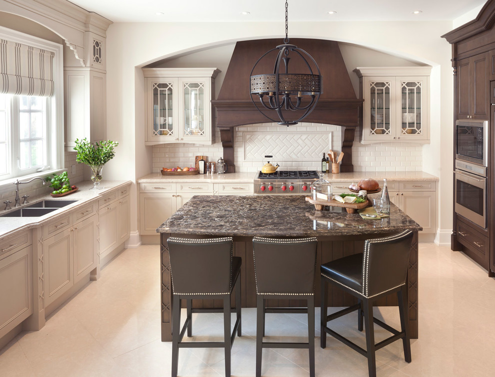 Mid-sized transitional l-shaped eat-in kitchen in Orlando with a double-bowl sink, shaker cabinets, beige cabinets, solid surface benchtops, white splashback, subway tile splashback, stainless steel appliances, porcelain floors and with island.