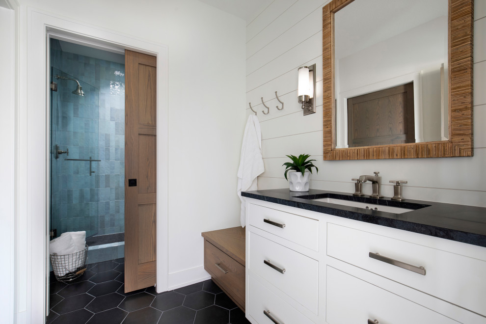 Photo of an expansive transitional 3/4 bathroom in Minneapolis with white cabinets, blue tile, ceramic tile, white walls, ceramic floors, a drop-in sink, engineered quartz benchtops, black floor, a hinged shower door, black benchtops, a single vanity, a built-in vanity and planked wall panelling.