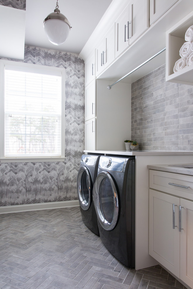 Inspiration for a transitional single-wall laundry room in Philadelphia with shaker cabinets, white cabinets, grey walls, a side-by-side washer and dryer, grey floor and white benchtop.