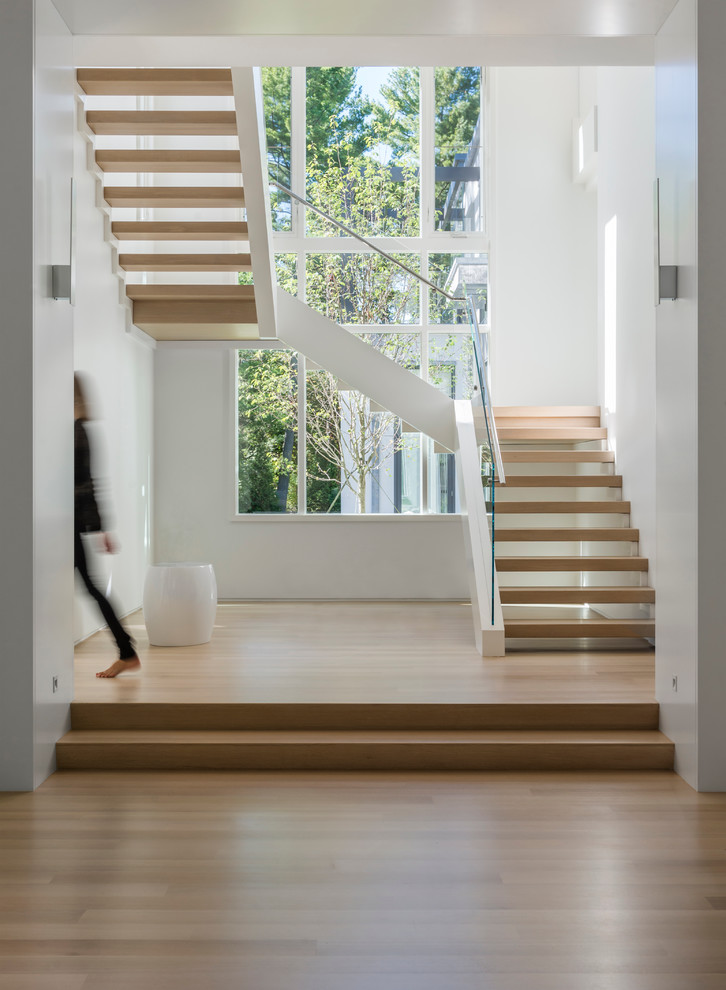 Inspiration for a contemporary wood u-shaped staircase in Boston with open risers.