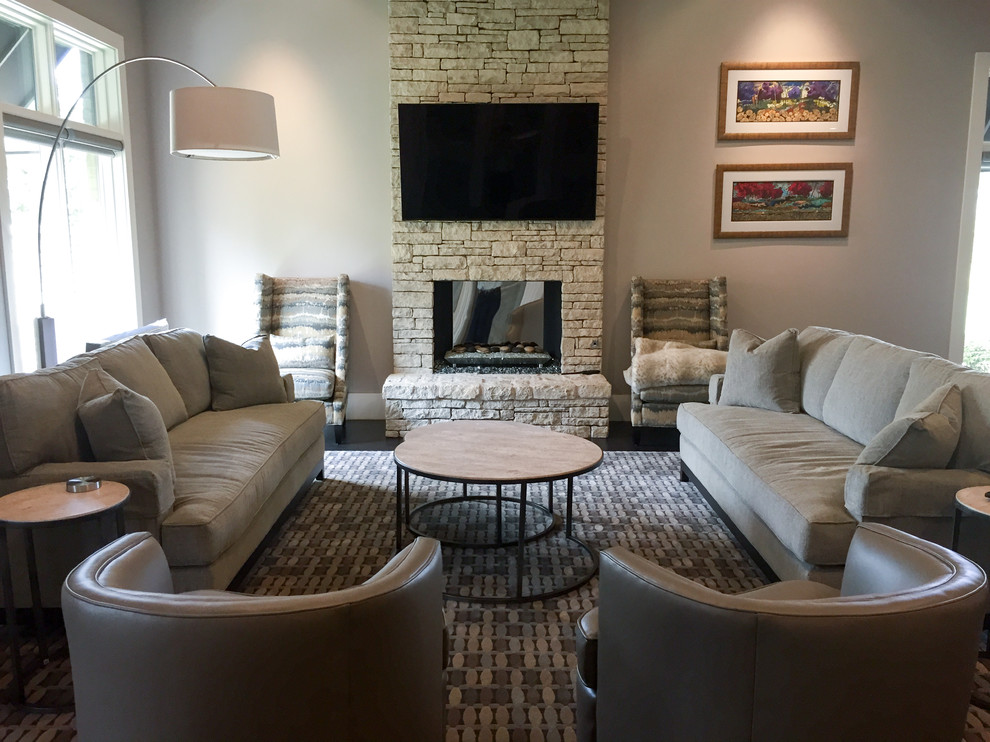 Photo of a mid-sized contemporary formal enclosed living room in Oklahoma City with grey walls, dark hardwood floors, a standard fireplace, a stone fireplace surround and no tv.