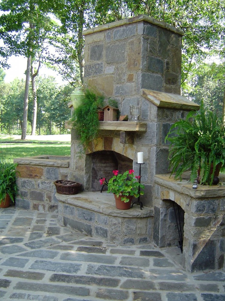 Inspiration for a mid-sized rustic backyard stone patio remodel in Phoenix with a fire pit