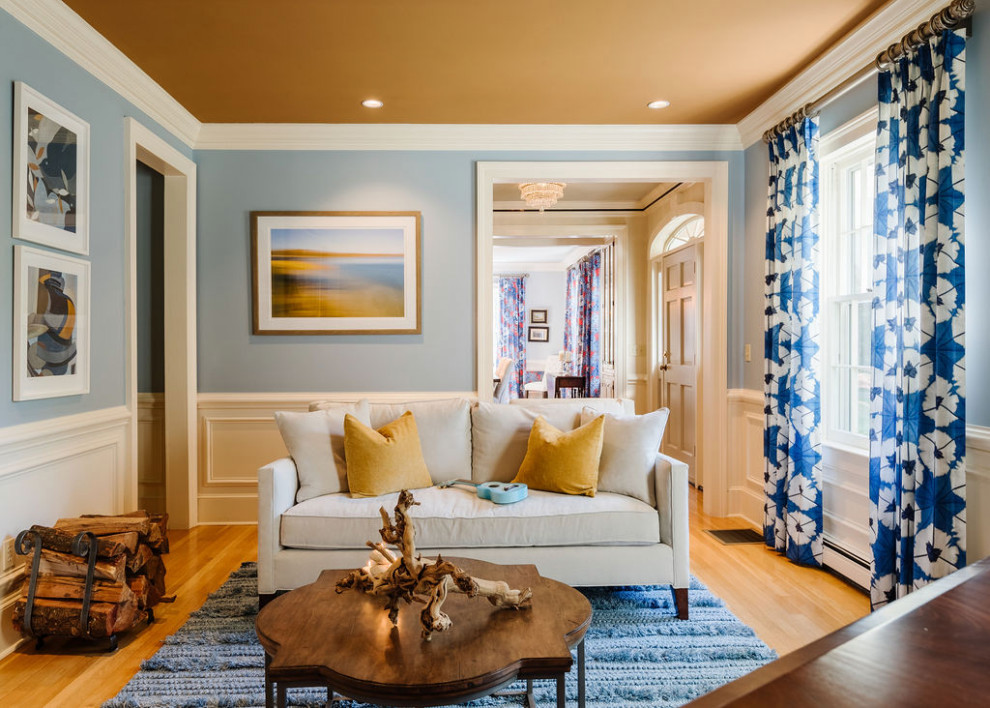 Photo of a medium sized classic living room in Boston with a music area, blue walls, light hardwood flooring, a standard fireplace, a wooden fireplace surround, beige floors, a drop ceiling and wallpapered walls.