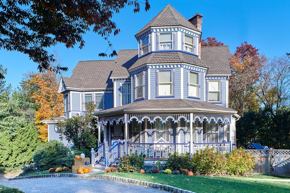 This is an example of a traditional three-storey blue house exterior in New York with a gable roof.