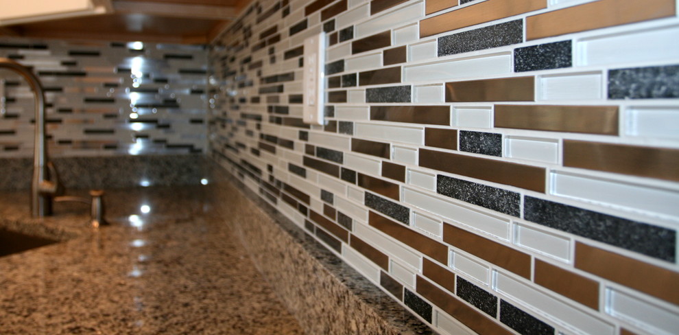 Kitchen - mid-sized modern medium tone wood floor kitchen idea in Baltimore with an undermount sink, white cabinets, granite countertops, multicolored backsplash, glass tile backsplash and stainless steel appliances