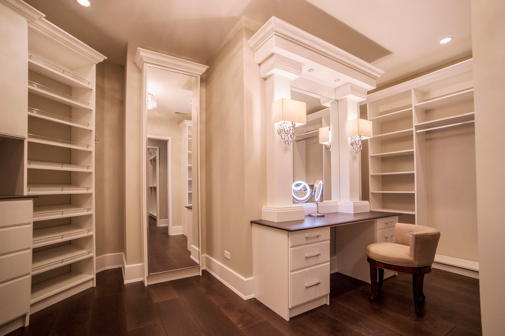 Design ideas for an expansive transitional women's walk-in wardrobe in Chicago with flat-panel cabinets, white cabinets and dark hardwood floors.