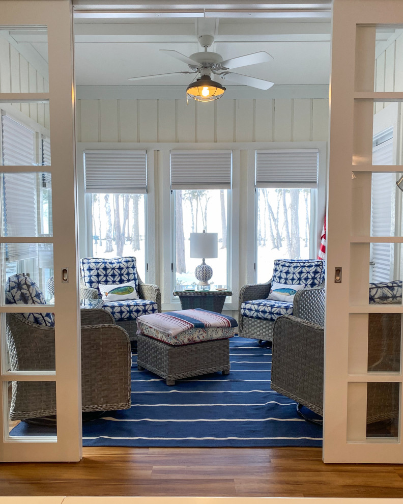 This is an example of a mid-sized beach style sunroom in Other with vinyl floors, a standard ceiling and brown floor.