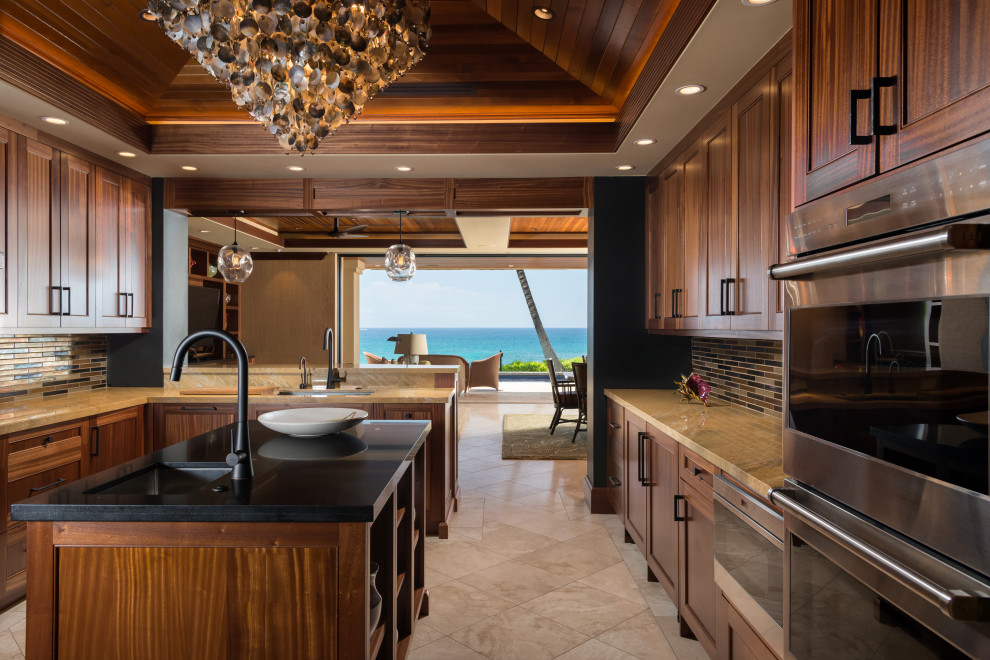 Inspiration for a tropical u-shaped kitchen in Hawaii with shaker cabinets, dark wood cabinets, mosaic tile splashback, stainless steel appliances, with island, beige floor, brown benchtop, vaulted and wood.