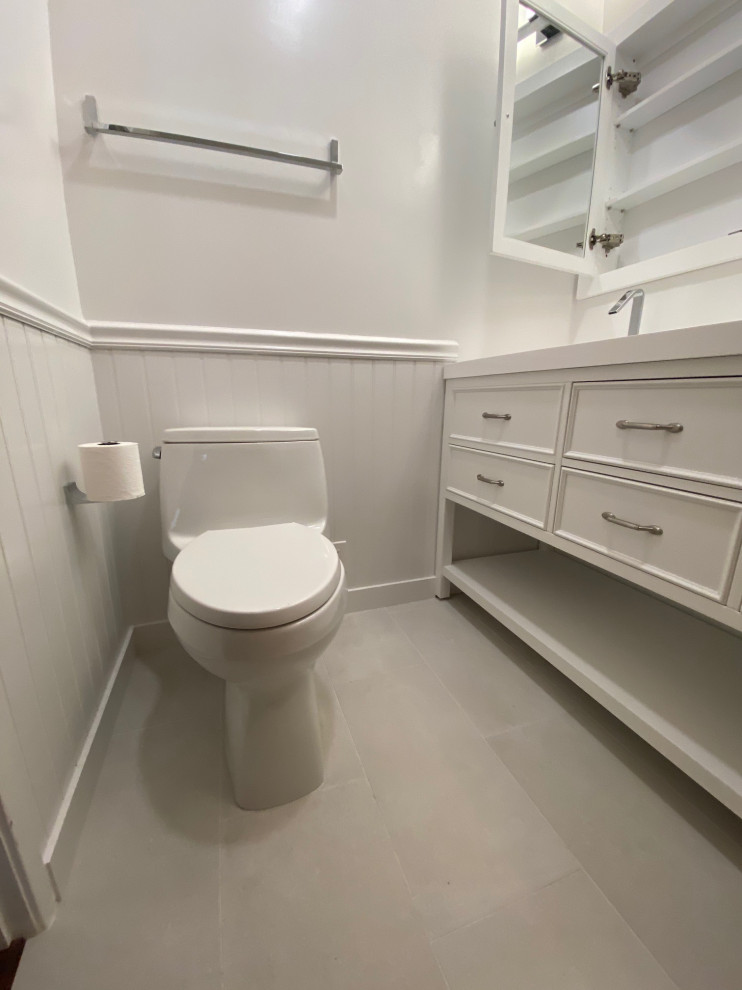 This is an example of a mid-sized modern 3/4 bathroom in San Francisco with beaded inset cabinets, white cabinets, a shower/bathtub combo, gray tile, white walls, quartzite benchtops, grey floor, a shower curtain, white benchtops, a niche, a double vanity, a built-in vanity, vaulted and panelled walls.