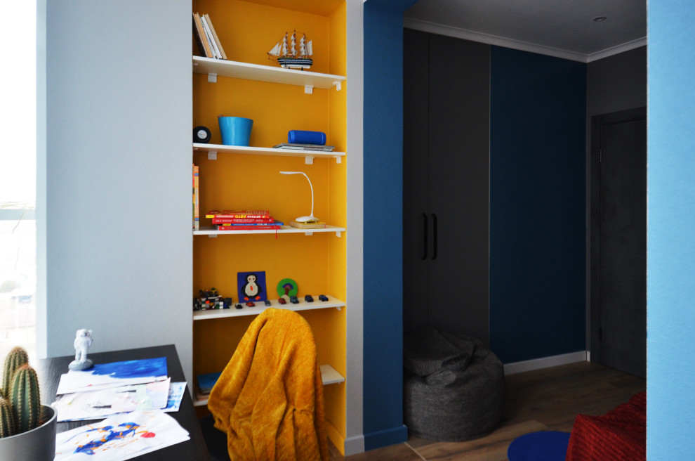 This is an example of a small contemporary teen’s room for boys in Other with grey walls, laminate floors, brown floors, wallpapered walls and feature lighting.