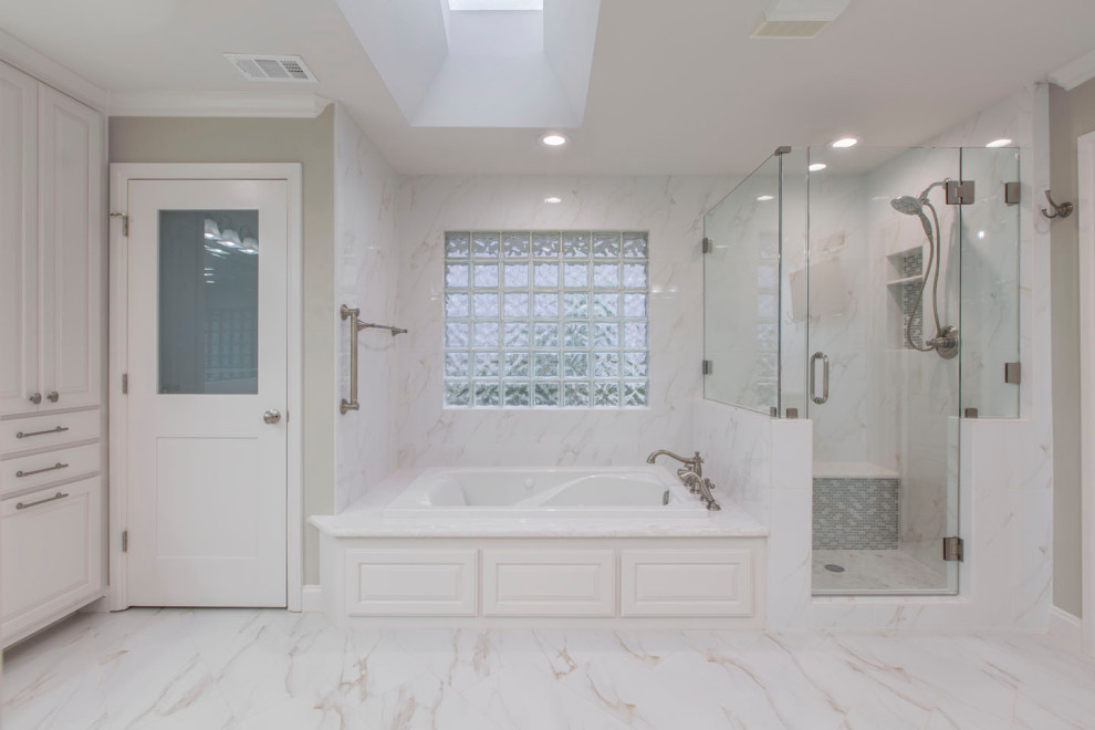 Large transitional master bathroom in Other with raised-panel cabinets, white cabinets, beige walls, mosaic tile floors, an undermount sink, engineered quartz benchtops, white floor, white benchtops, a drop-in tub, a corner shower, a two-piece toilet, white tile, mosaic tile and a hinged shower door.
