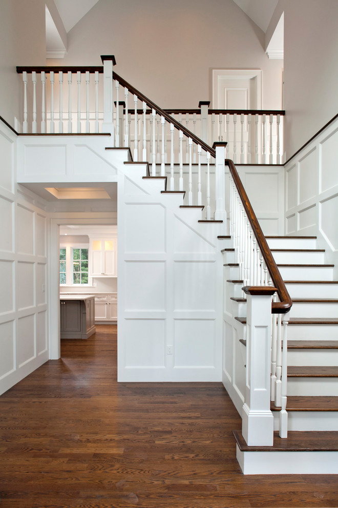 Mid-sized wood l-shaped staircase in Boston with painted wood risers and wood railing.