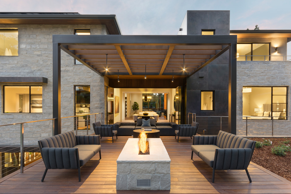 Inspiration for a contemporary backyard deck in Orange County with a fire feature and no cover.