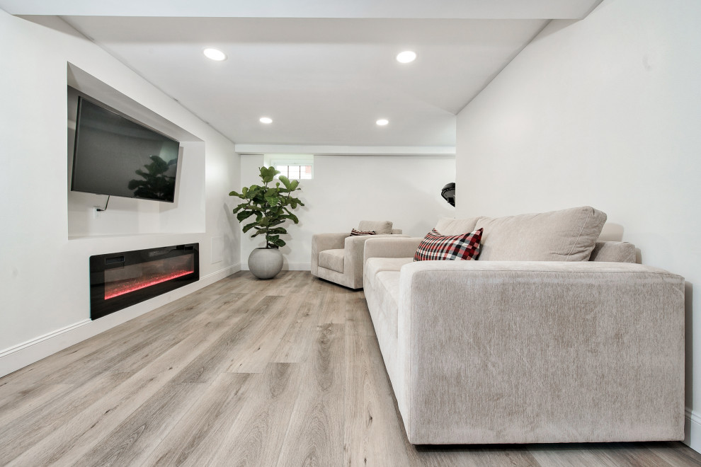 Design ideas for a small modern look-out basement in San Diego with a home cinema, white walls, vinyl flooring, all types of fireplace, all types of fireplace surround, beige floors, exposed beams and all types of wall treatment.