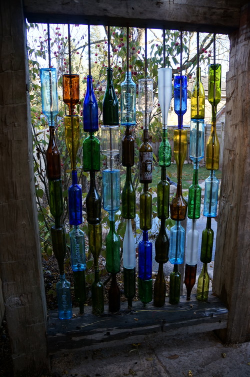 Here is an example that shows that privacy screens can really break the mold. This is a very creative idea using found materials. In this case, glass bottles were utilized. Using colored glass can make your space visually interesting when the sun breaks through and passes through the glass walls.