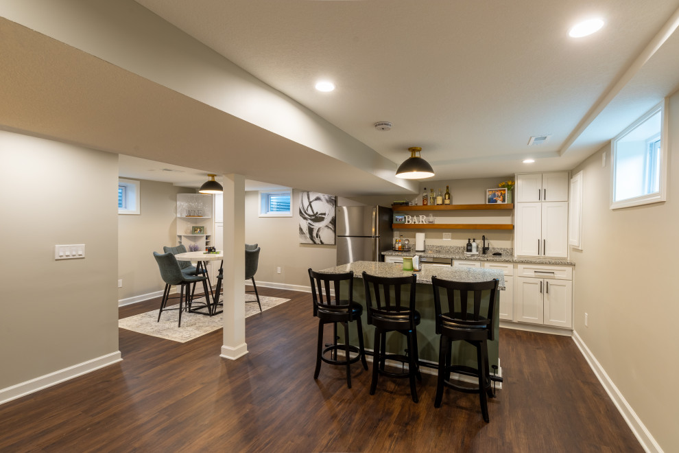 Photo of a medium sized traditional basement in Kansas City with a home bar and beige walls.