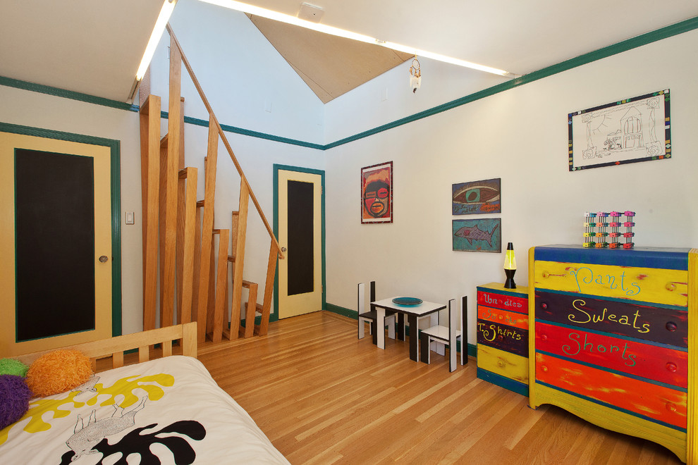 Mid-sized contemporary kids' room in San Francisco with white walls and light hardwood floors for boys.