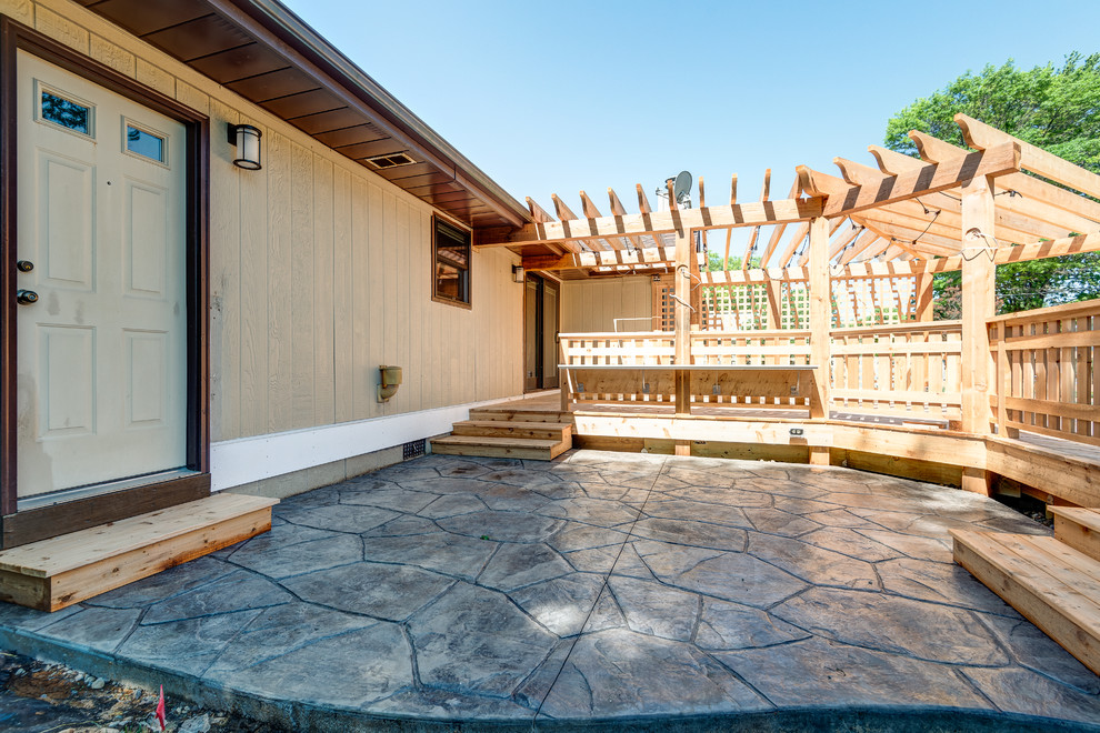 Deck - large transitional backyard deck idea in Chicago with a pergola