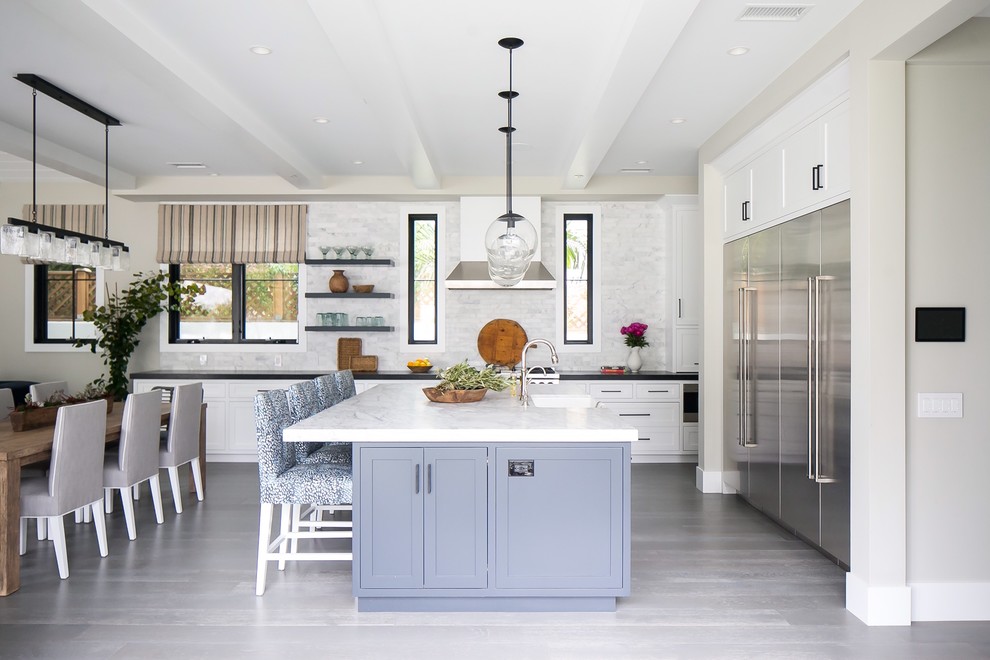Design ideas for a large transitional open plan kitchen in Orange County with shaker cabinets, white cabinets, marble benchtops, grey splashback, marble splashback, stainless steel appliances, medium hardwood floors, with island and grey floor.
