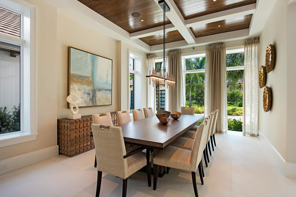 This is an example of a large transitional separate dining room in Miami with beige walls, ceramic floors and no fireplace.