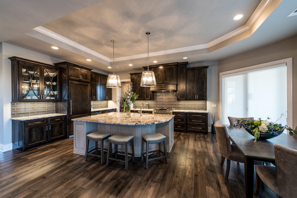 Transitional l-shaped open plan kitchen in Kansas City with an undermount sink, beaded inset cabinets, dark wood cabinets, granite benchtops, brown splashback, matchstick tile splashback, stainless steel appliances, dark hardwood floors and with island.